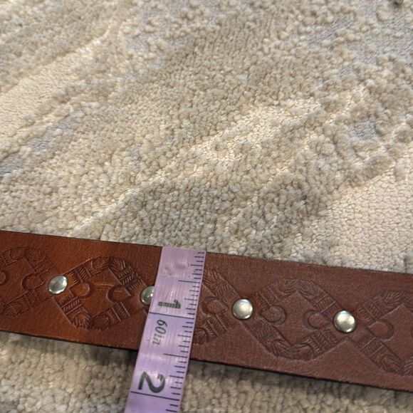 Vintage Linea Pelle studded leather belt with floral two toned metal buckle